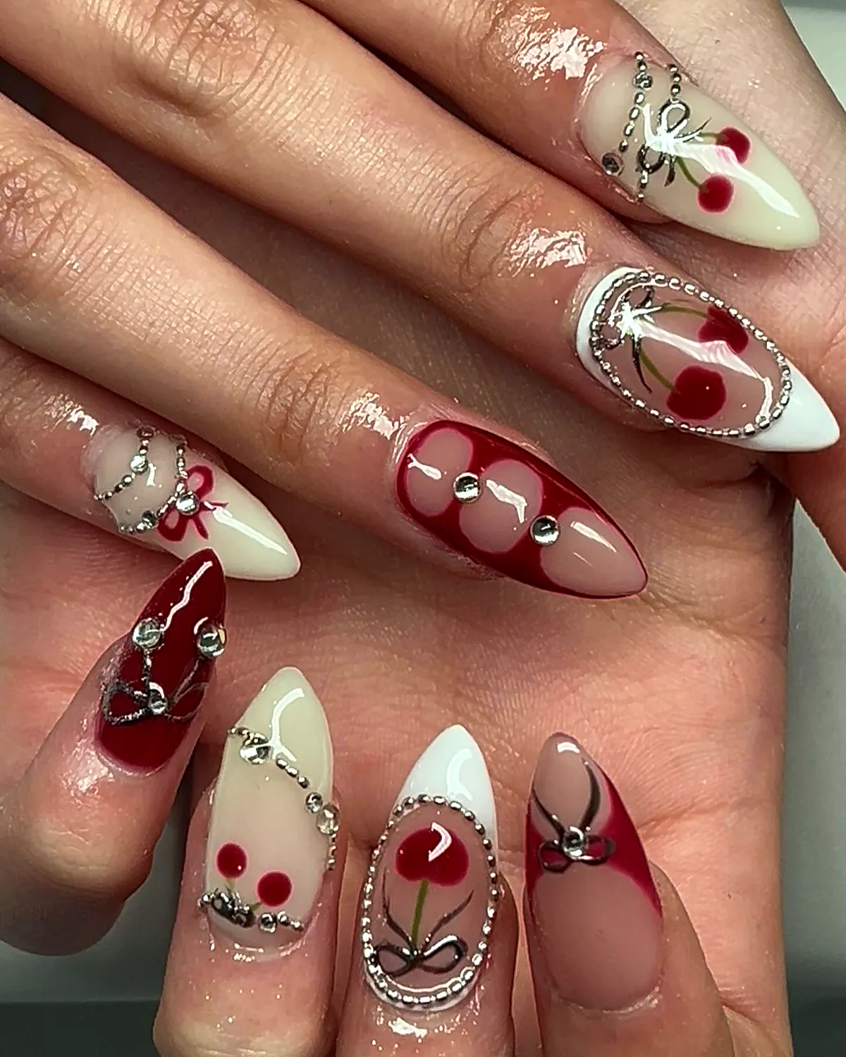 Cream and red stilettos with painted cherries, a cherry charm and silver chrome