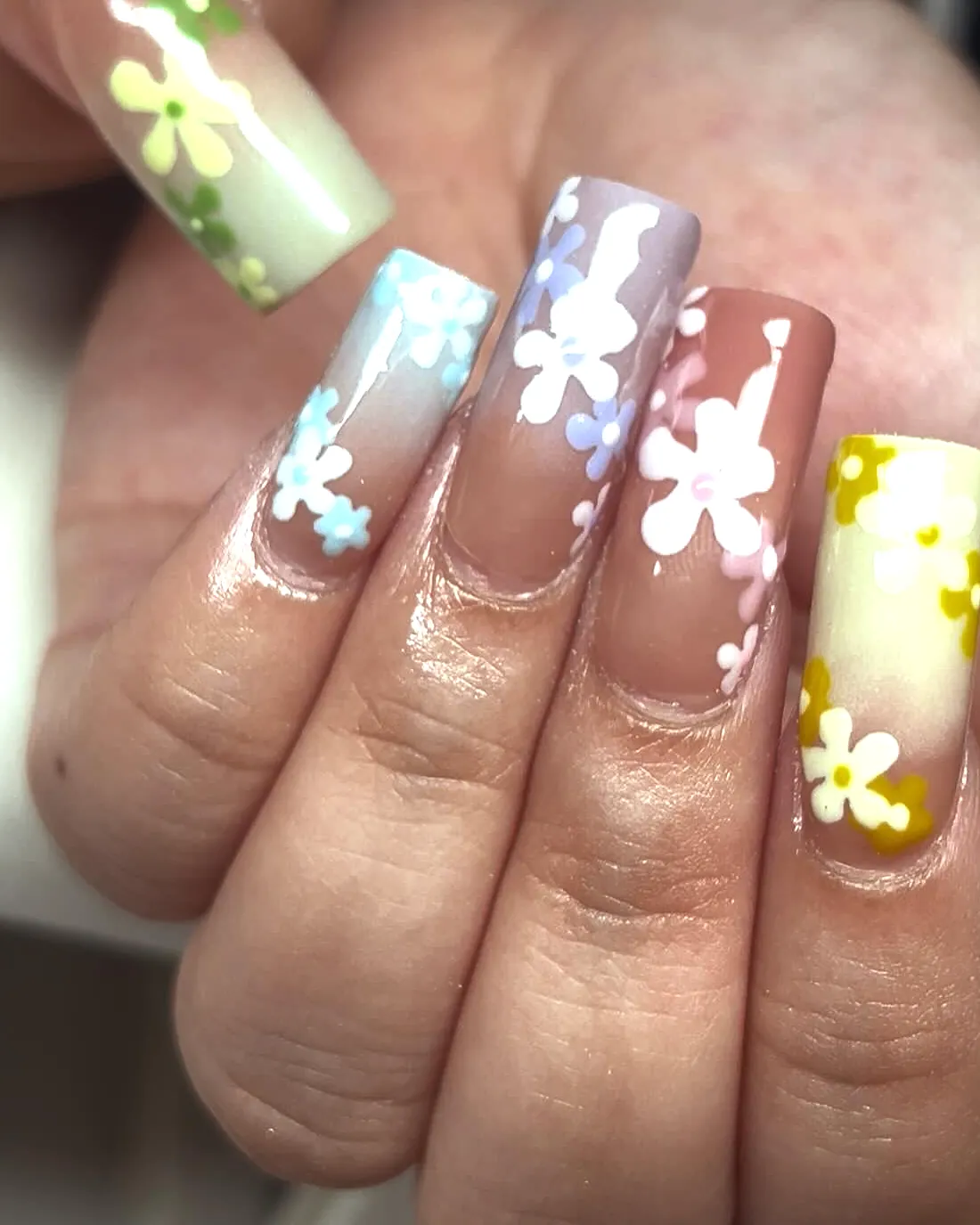 Long square nails with hand-painted pastel flowers, a simple tier set